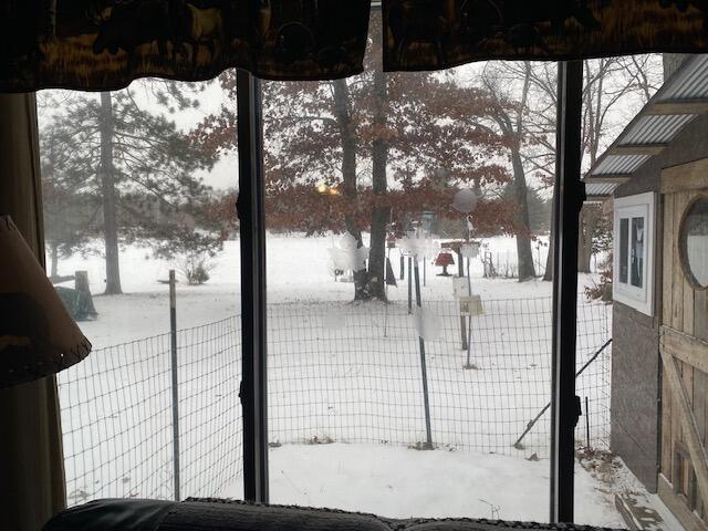 yard covered in snow featuring fence