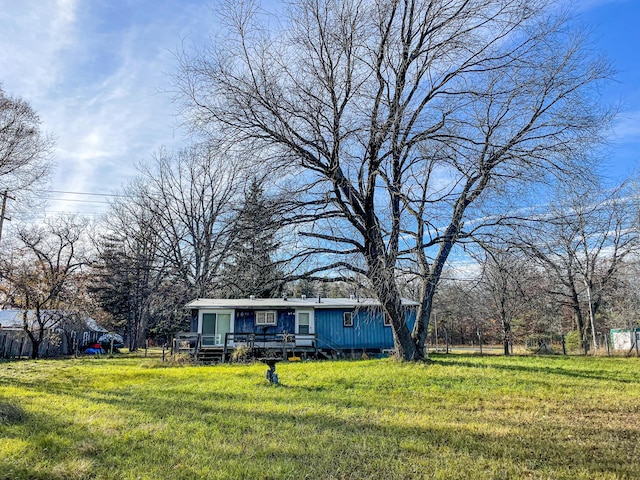 view of front of property with a deck and a front yard