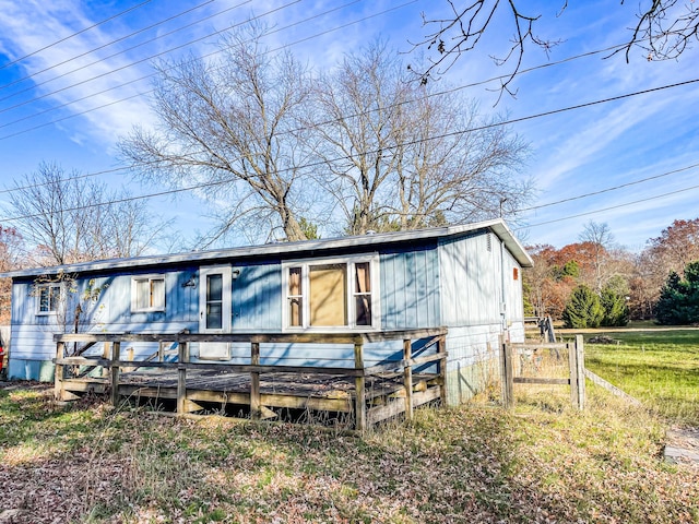 view of front of home with fence and a wooden deck