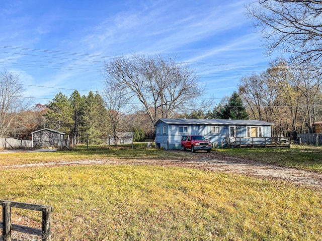 view of yard featuring fence and driveway