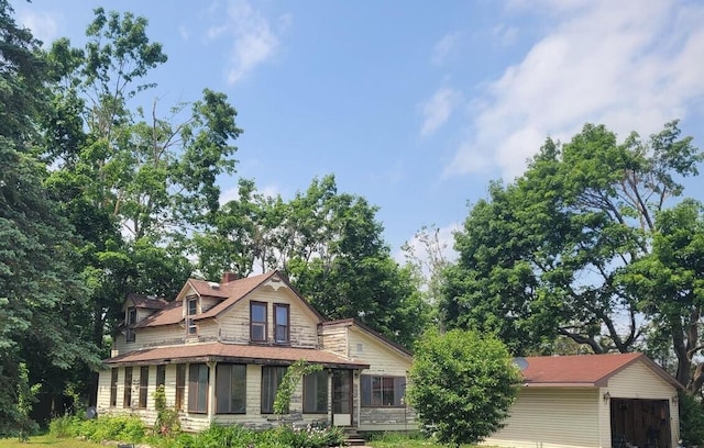 3864 S Elm St, Onaway, MI 49765 - rear view of house with a chimney