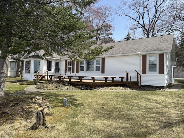 rear view of house with a lawn, roof with shingles, a chimney, and entry steps