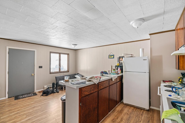 2862 Arlene, Indian River, MI 49749 - kitchen featuring freestanding refrigerator, a peninsula, light wood-style floors, range, and ornamental molding