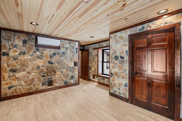 hall featuring a wall mounted air conditioner, light wood-type flooring, wooden ceiling, and ornamental molding