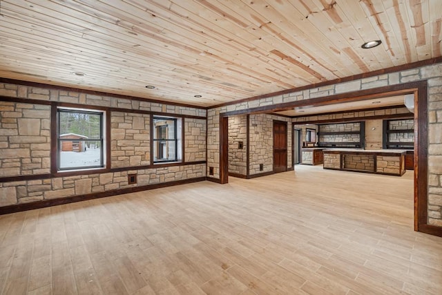 unfurnished living room featuring light wood-style flooring and wooden ceiling