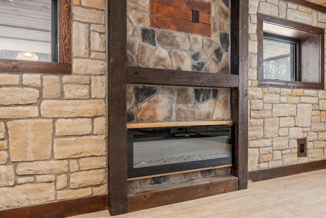 room details featuring a fireplace and wood finished floors