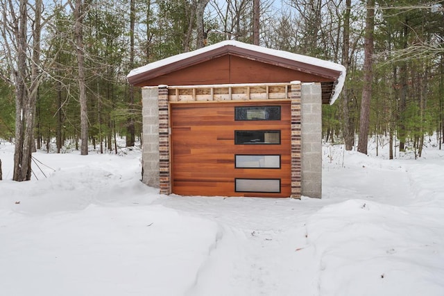 snow covered structure featuring an outdoor structure