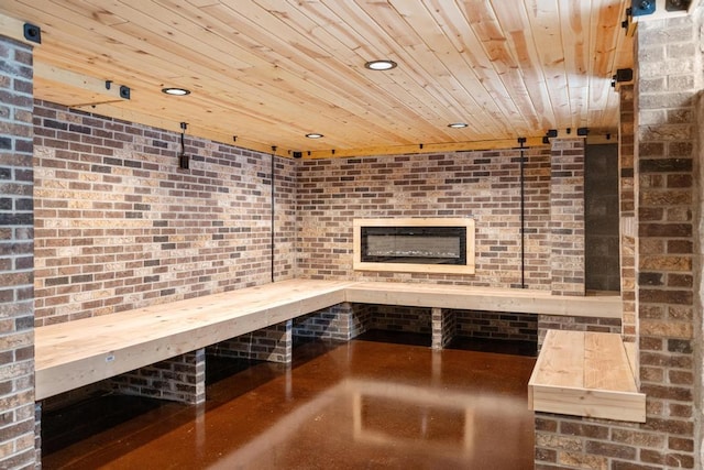 view of sauna with recessed lighting, brick wall, and finished concrete floors