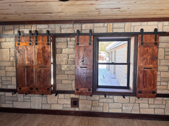 room details with a barn door and wood finished floors