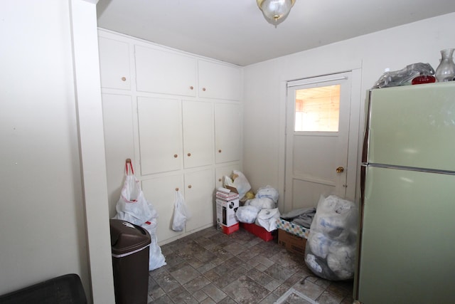 washroom featuring stone finish floor