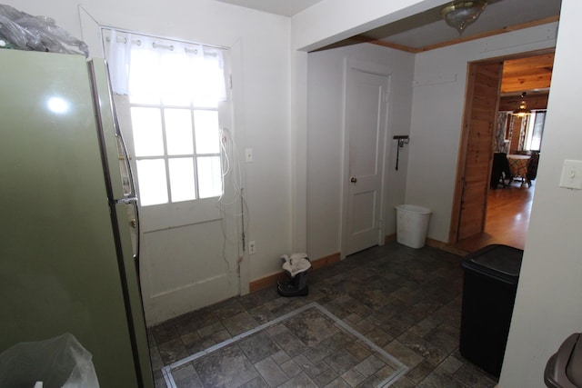 interior space with baseboards and stone finish flooring