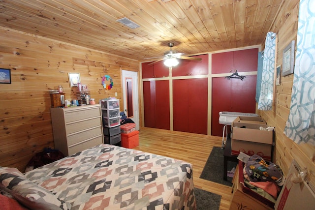 bedroom with visible vents, wood ceiling, and light wood-style floors