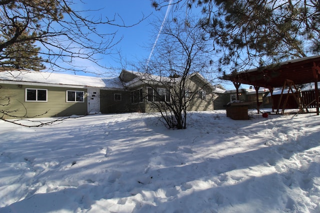 view of snow covered rear of property