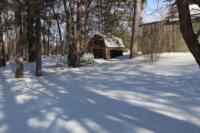 yard covered in snow featuring an outdoor structure