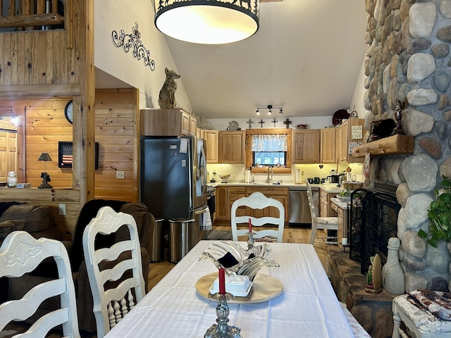 dining room with high vaulted ceiling