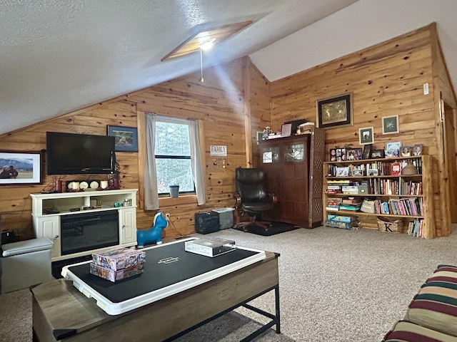 carpeted living room with wooden walls and vaulted ceiling