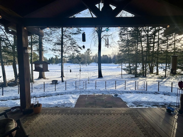 snowy yard with fence