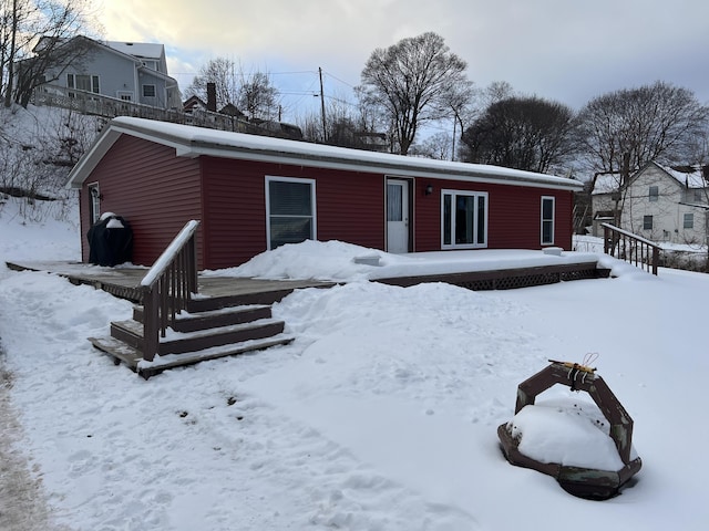 view of snow covered back of property