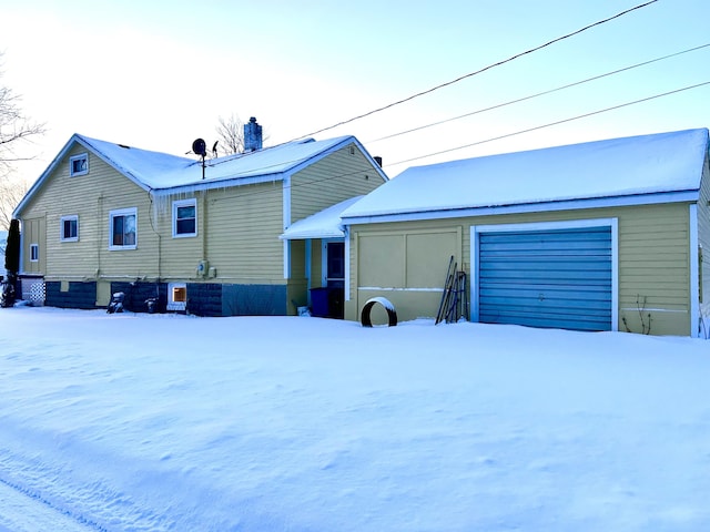 exterior space with a garage and a chimney