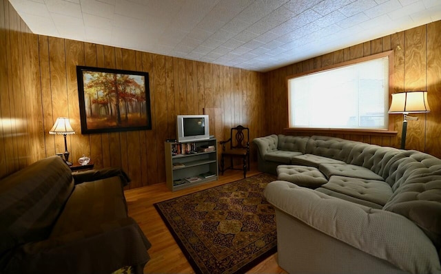 living room with wooden walls and wood finished floors