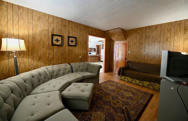 living room featuring wood finished floors and wood walls