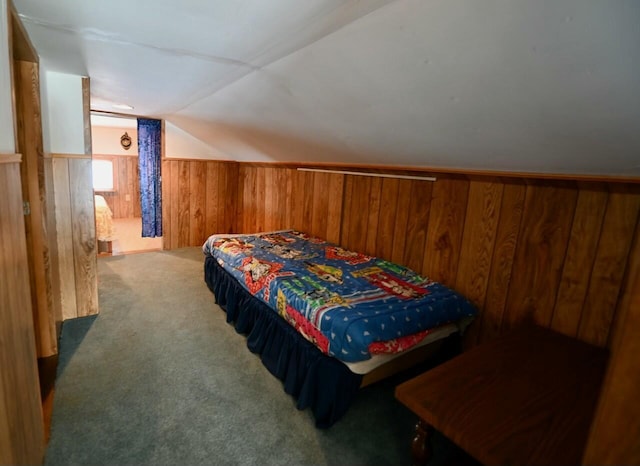 bedroom with lofted ceiling, wooden walls, and carpet flooring