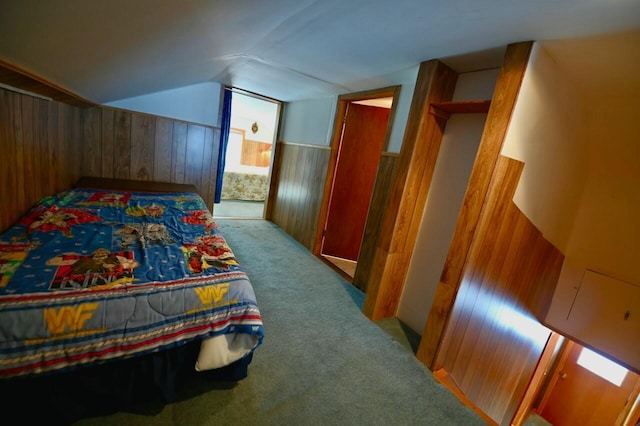 bedroom with lofted ceiling, wooden walls, a wainscoted wall, and carpet floors