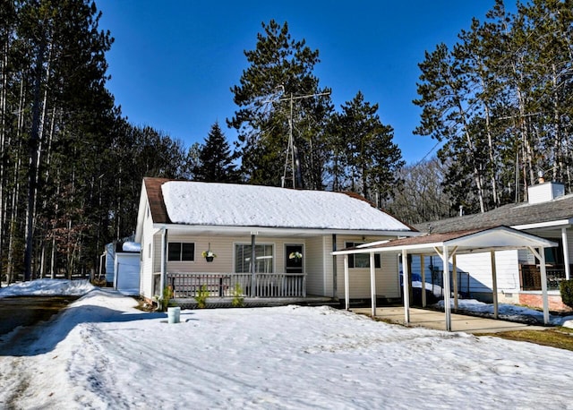 ranch-style home with a carport and covered porch