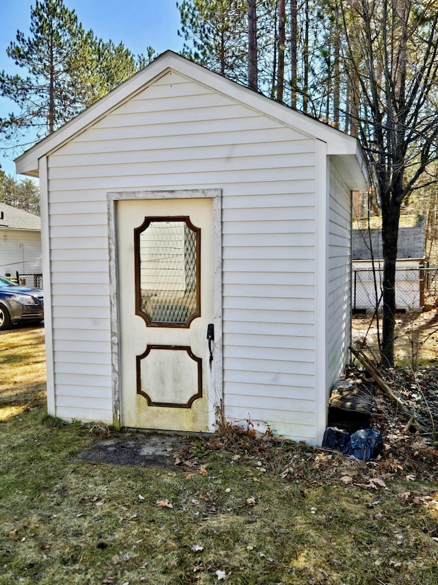 view of outbuilding featuring an outbuilding and fence