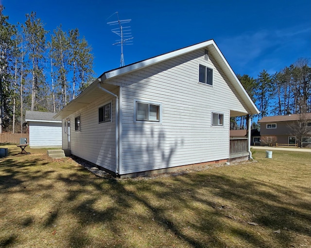 view of side of property with crawl space and a yard