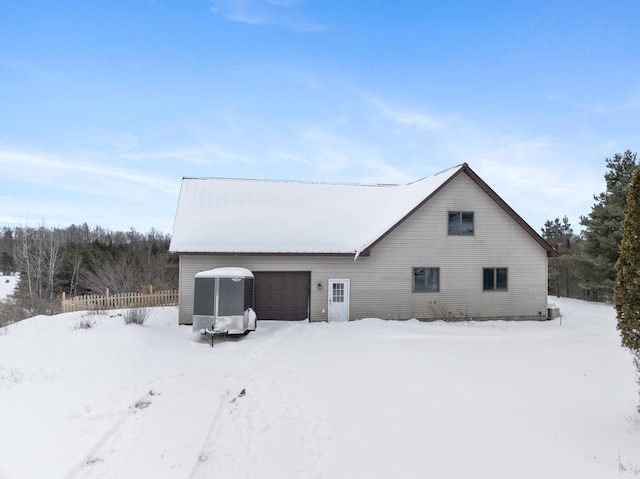 view of snow covered rear of property