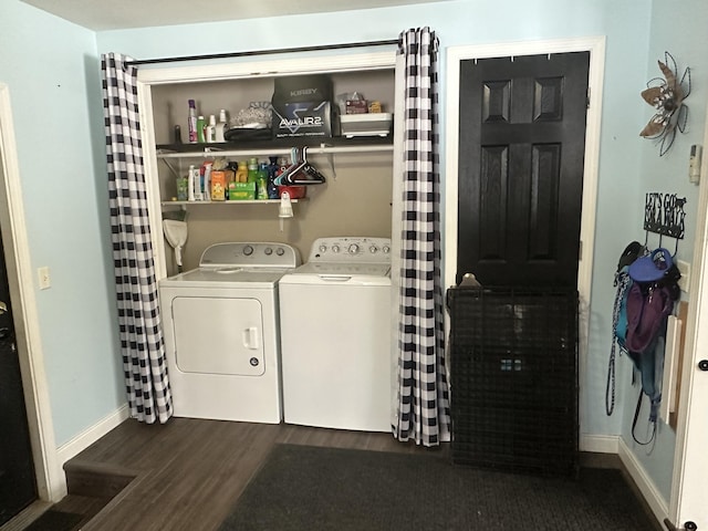 washroom featuring dark wood-type flooring, washing machine and dryer, baseboards, and laundry area