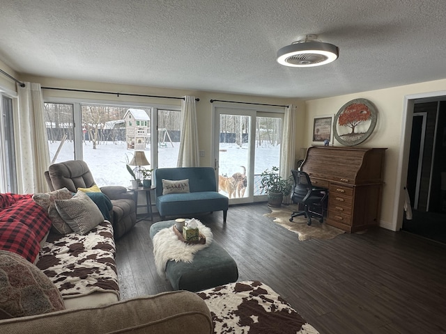 living area featuring a textured ceiling and wood finished floors