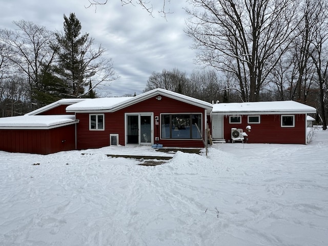 view of snow covered back of property