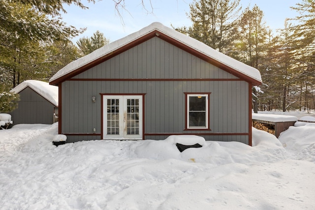 snow covered property with french doors