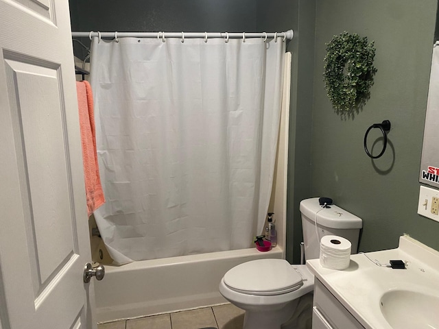 bathroom featuring vanity, toilet, shower / tub combo, and tile patterned flooring