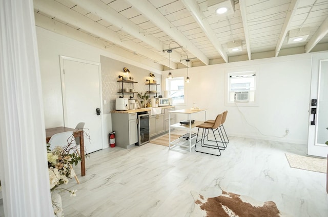 dining room with beam ceiling, wine cooler, cooling unit, and wooden ceiling