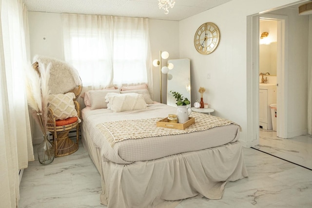 bedroom featuring marble finish floor and a sink