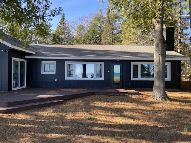 view of front of house featuring board and batten siding and a wooden deck