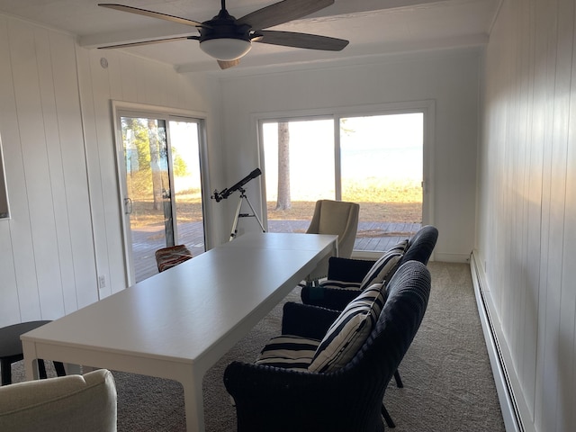 office area with wooden walls, a baseboard heating unit, ceiling fan, beam ceiling, and carpet flooring