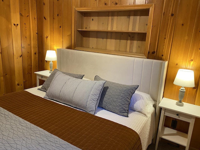 bedroom featuring wooden walls