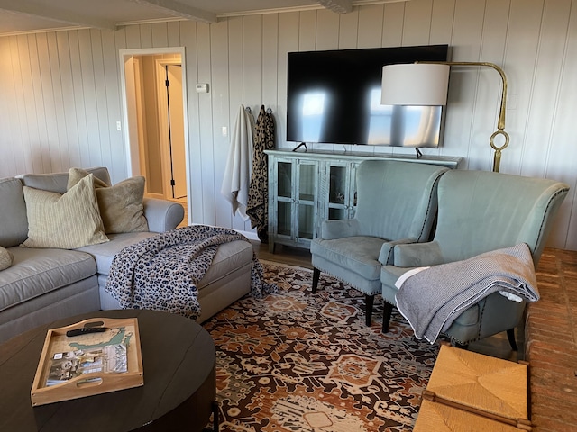 living area featuring beamed ceiling