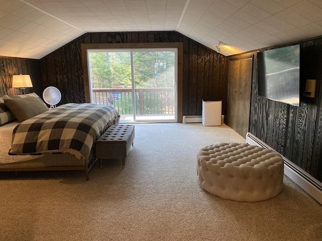 carpeted bedroom featuring a baseboard heating unit, access to exterior, wood walls, and vaulted ceiling