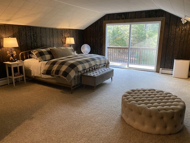 carpeted bedroom featuring baseboard heating, wood walls, vaulted ceiling, and access to outside