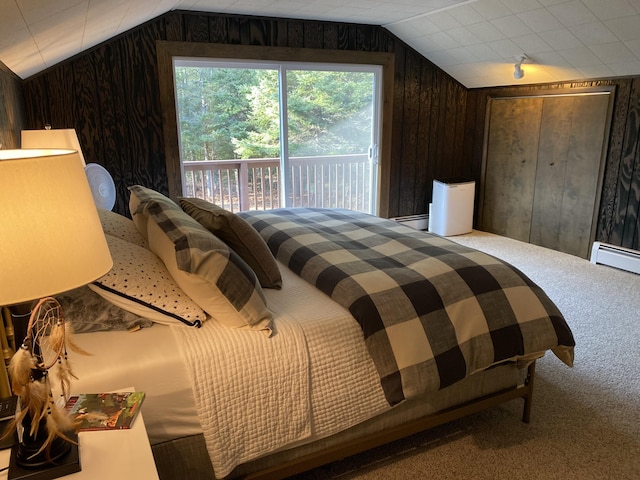 carpeted bedroom featuring vaulted ceiling, wooden walls, and access to outside