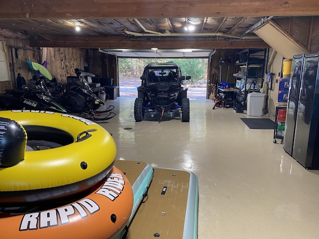 garage featuring wood walls