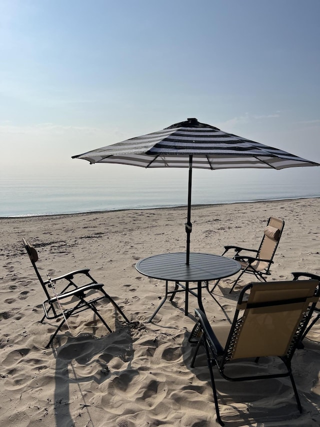 exterior space featuring a view of the beach and a water view