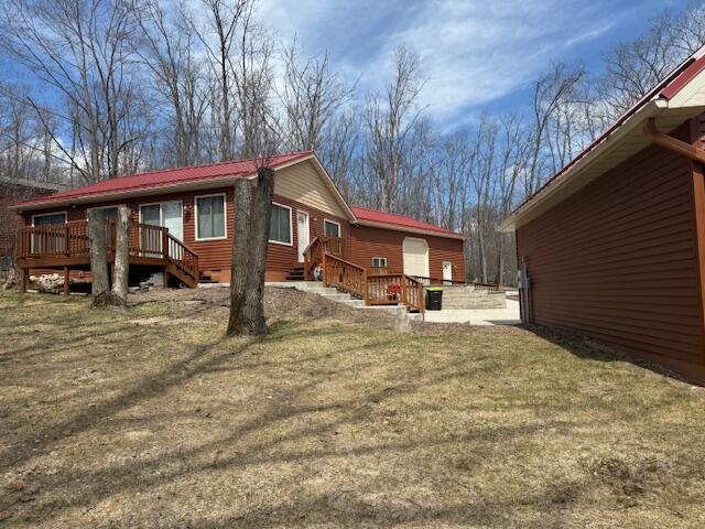 view of property exterior featuring a deck and crawl space