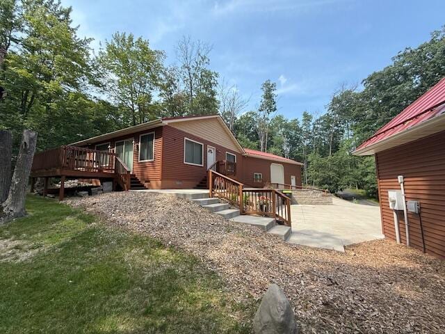 100 Innsbruck Ave, Roscommon, MI 48653 - rear view of house with a wooden deck, a patio area, and crawl space