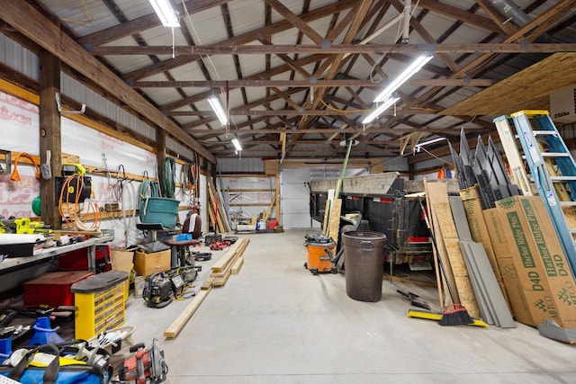 garage with metal wall and a workshop area